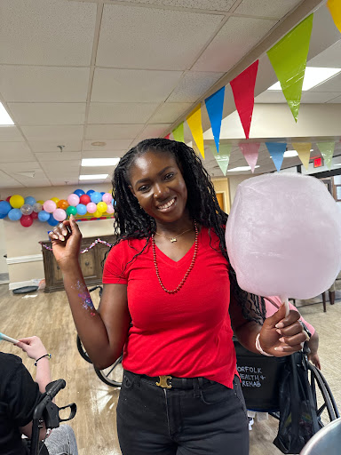 A joyful moment at a celebration with cotton candy and colorful decor.