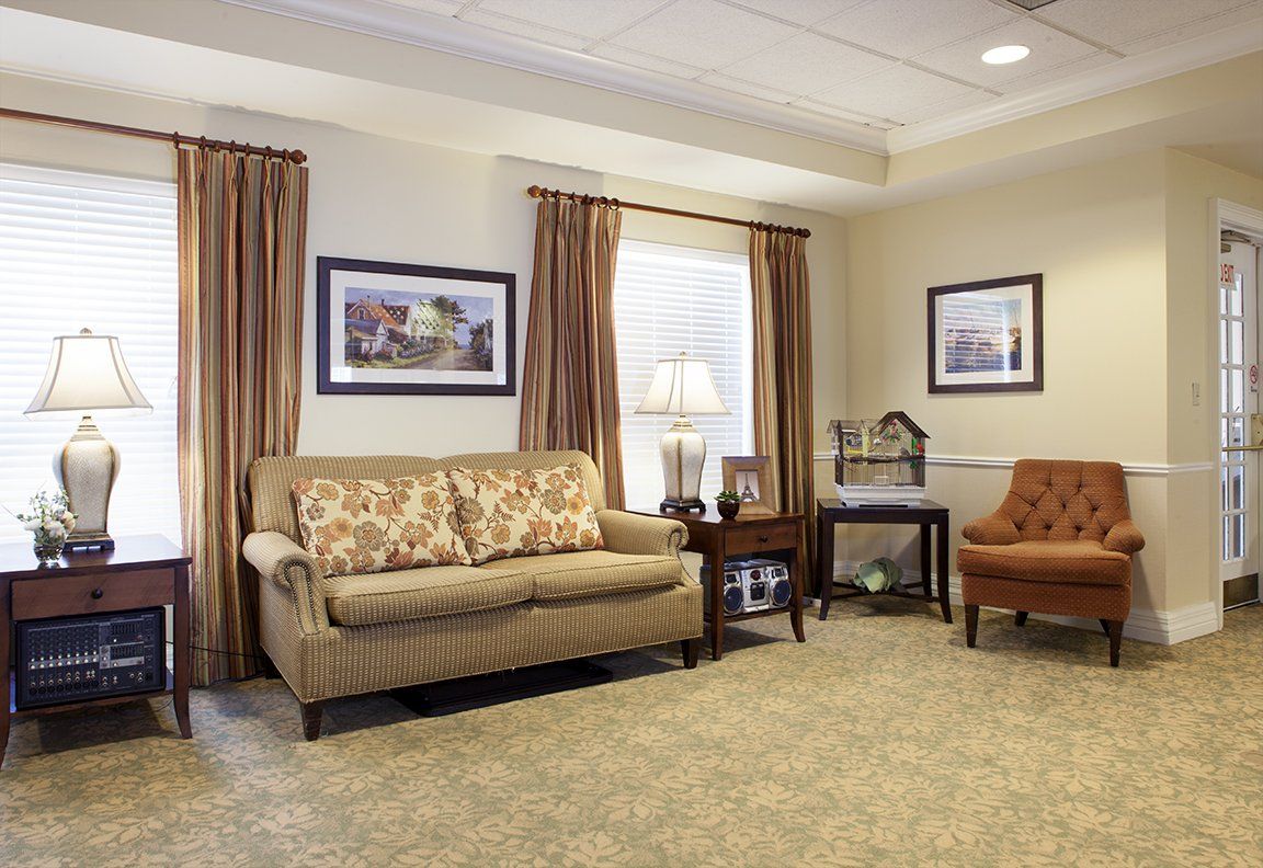 A cozy living room with a sofa, armchair, and elegant decor.