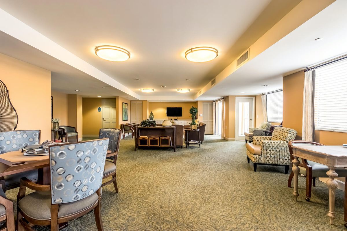 A spacious and well-lit living room with comfortable seating and modern decor.
