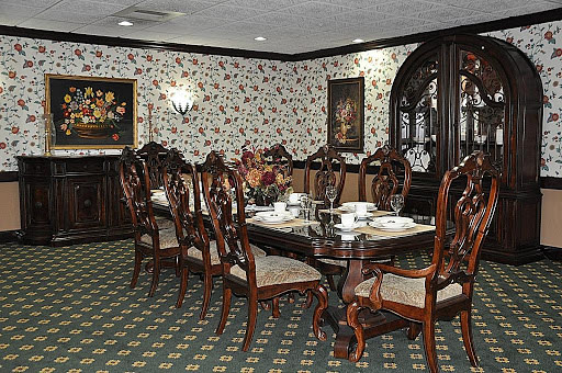 A classic and elegantly furnished dining room with a formal table setting.