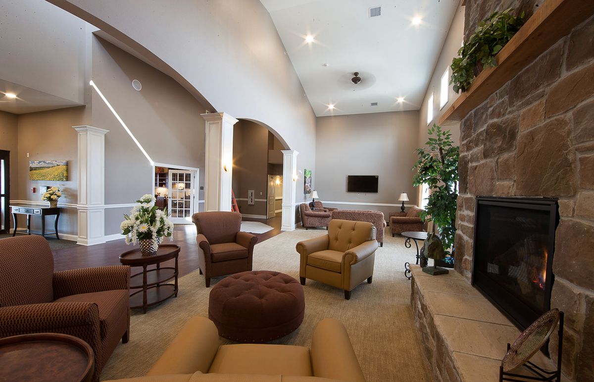A spacious and elegantly designed living room with comfortable seating, a fireplace, and modern decor.