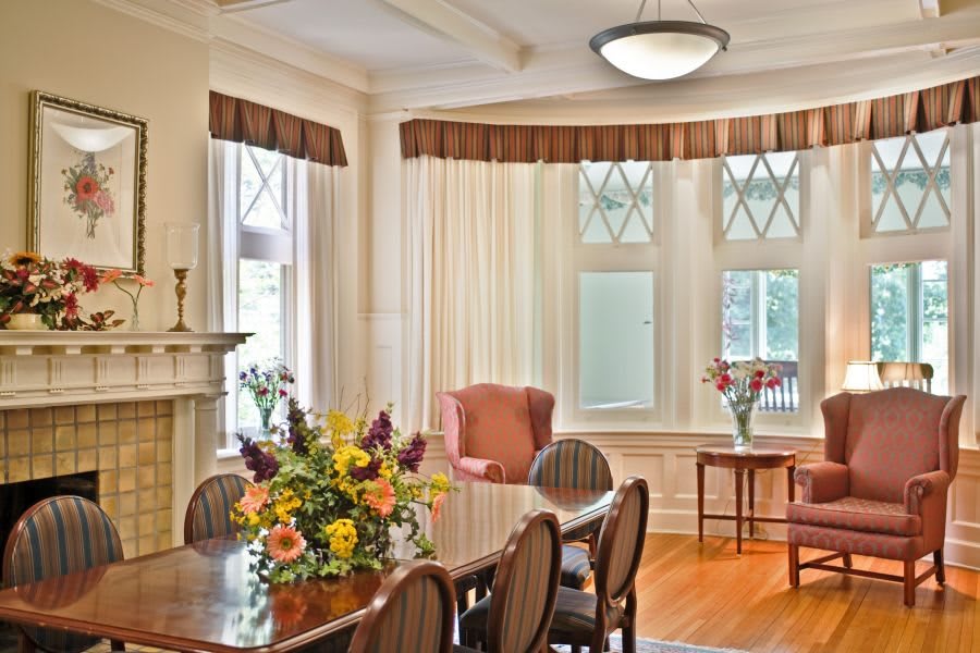 A beautifully furnished dining room with elegant decor and a large table set for gathering.