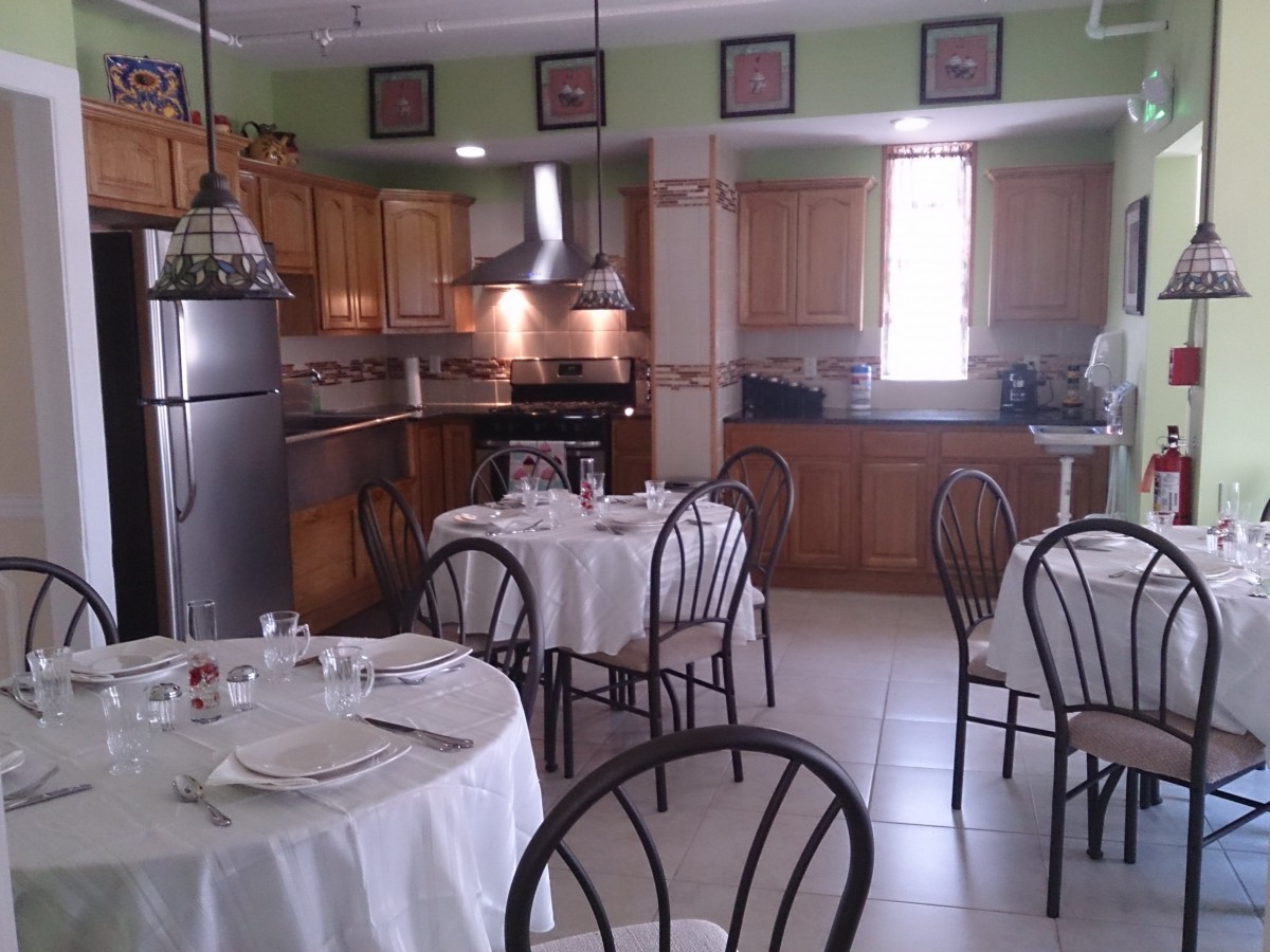 A cozy dining area with round tables set in a kitchen environment.