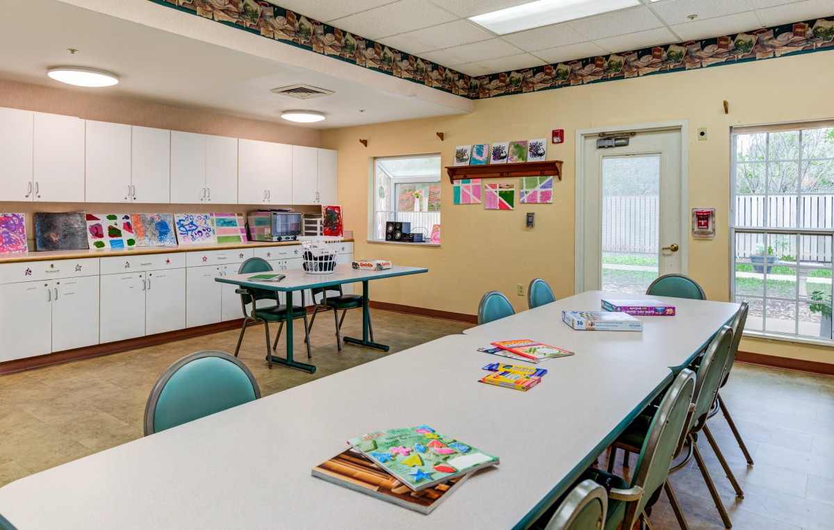 A well-organized classroom with tables, chairs, and educational materials ready for students.