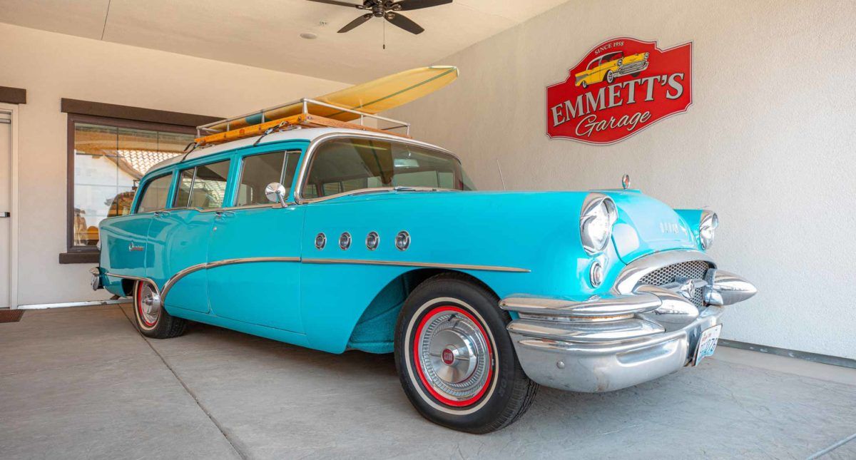 A turquoise vintage Buick station wagon from the 1950s displayed indoors.