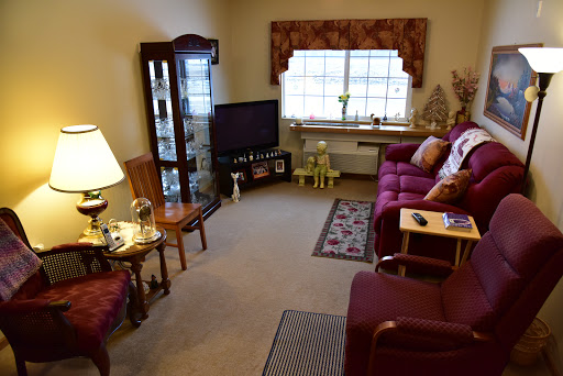 A cozy living room featuring a comfortable sofa, a television setup, and decorative furnishings.