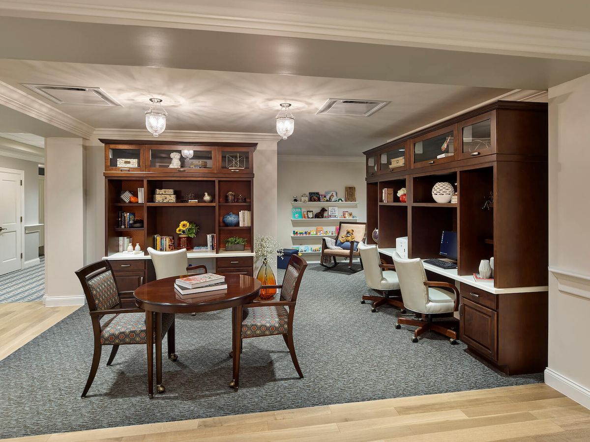 A modern office interior with workspaces and a meeting area.