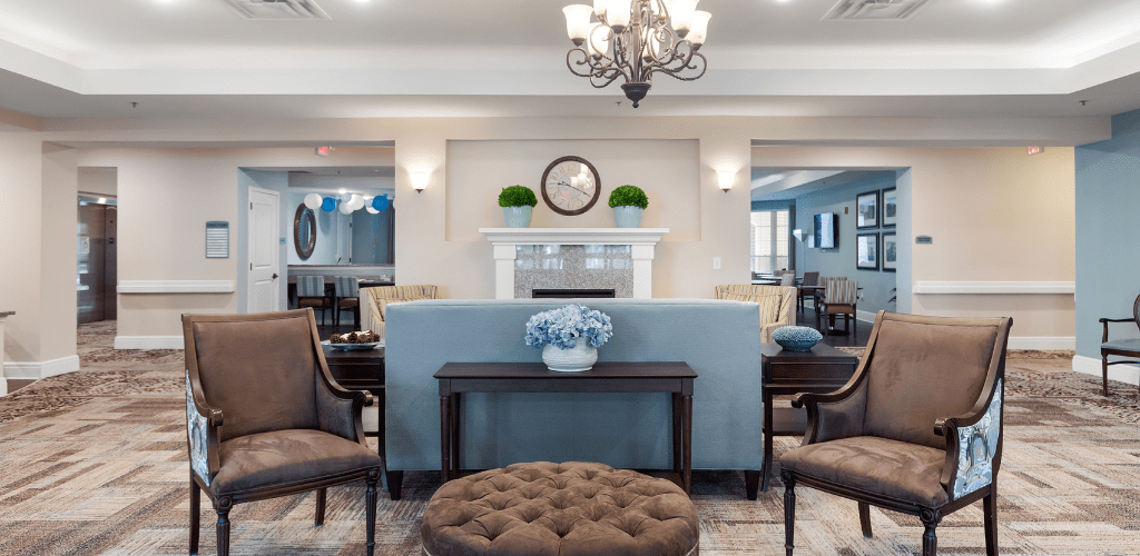 A beautifully decorated living room featuring a classic and elegant interior design with a chandelier, sofa, and stylish furnishings.
