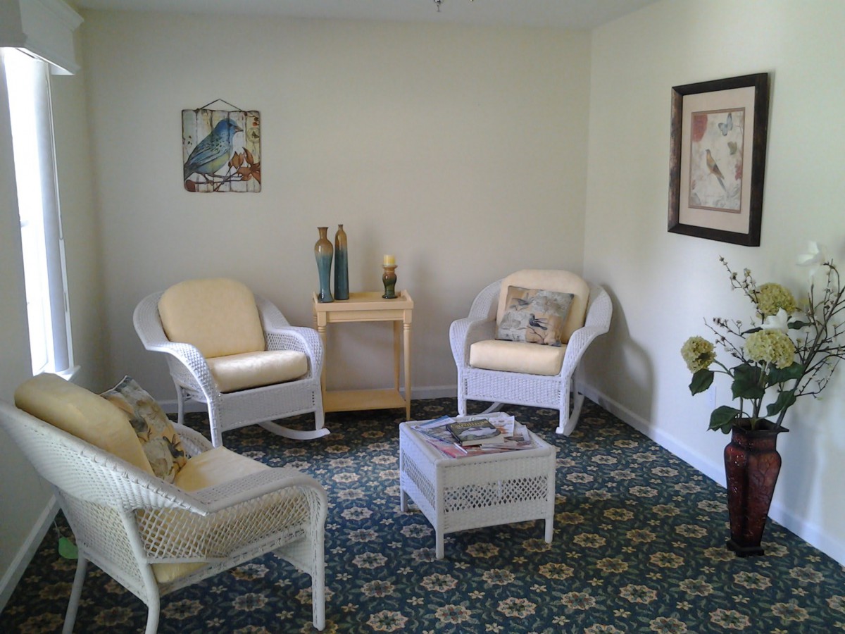Cozy living room with wicker furniture and decorative elements.