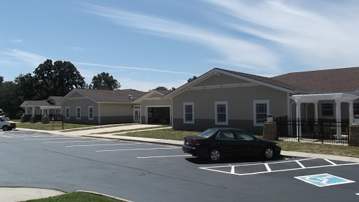 A view of a suburban residential area with several buildings and a parked car.