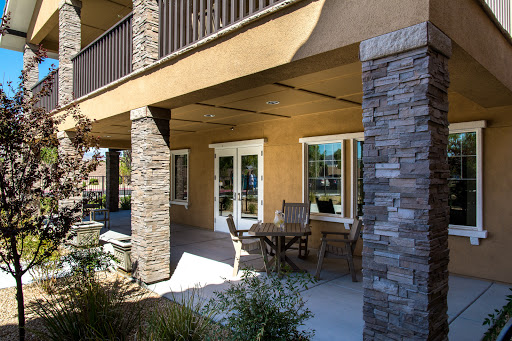 A modern outdoor patio area featuring stone and wood elements, perfect for relaxation.