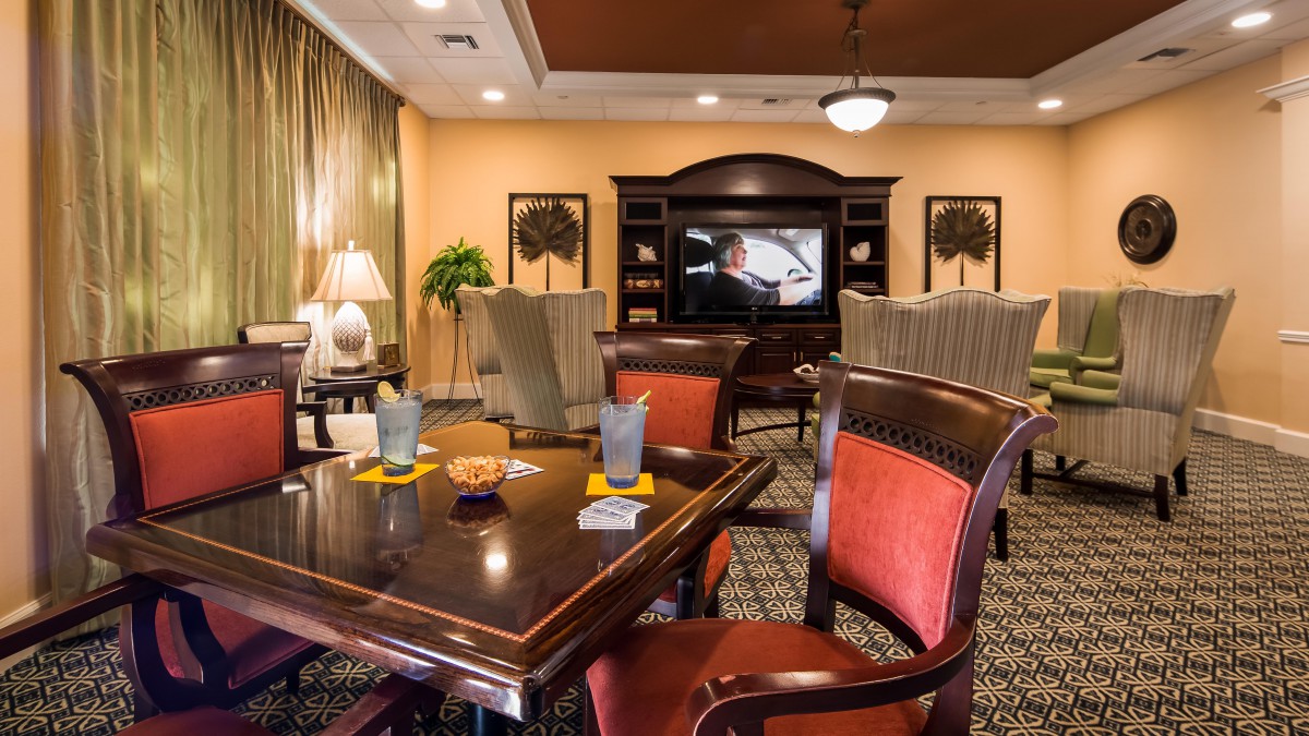 A cozy living room with elegant furniture, a television, and tasteful decor.