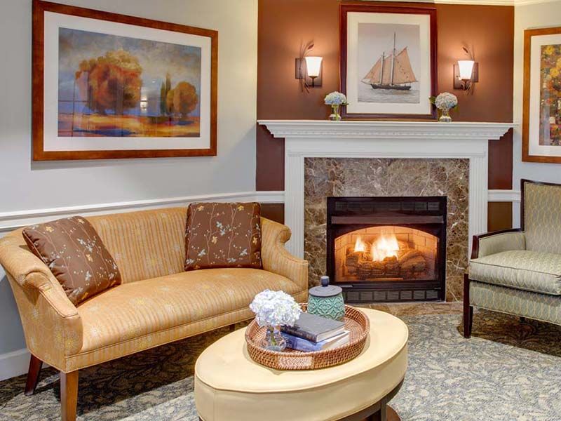 Cozy living room with a warm fireplace and elegant decor.
