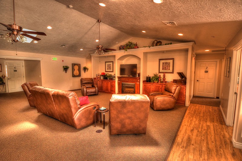 A cozy living room with sofas, a fireplace, and a television.