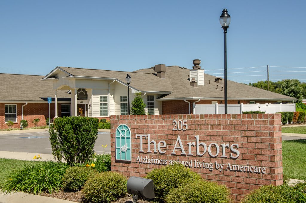 The Arbors, a retirement living facility with a welcoming entrance and landscaped grounds.