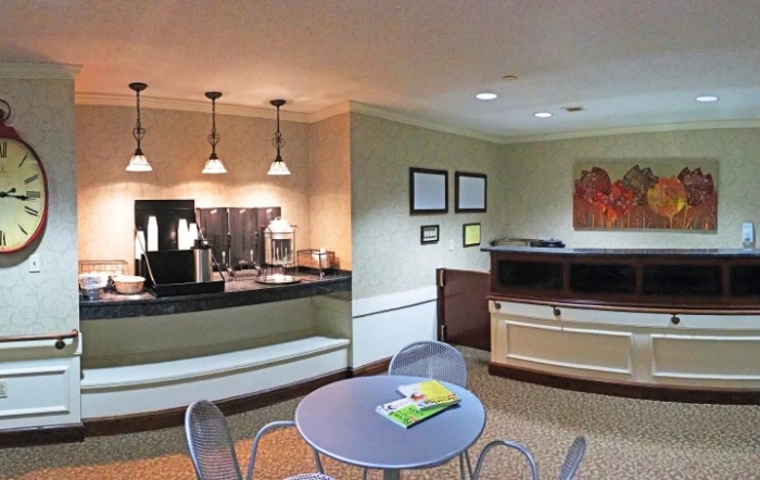 A cozy lobby area with a coffee station and seating arrangements.