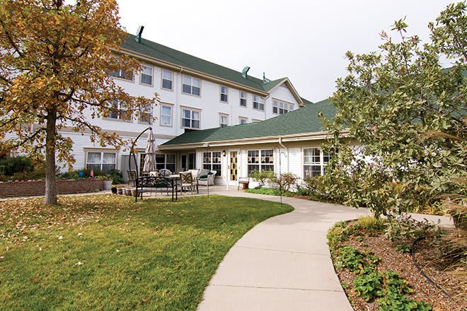 A well-maintained outdoor area with a pathway leading to a multi-story building.