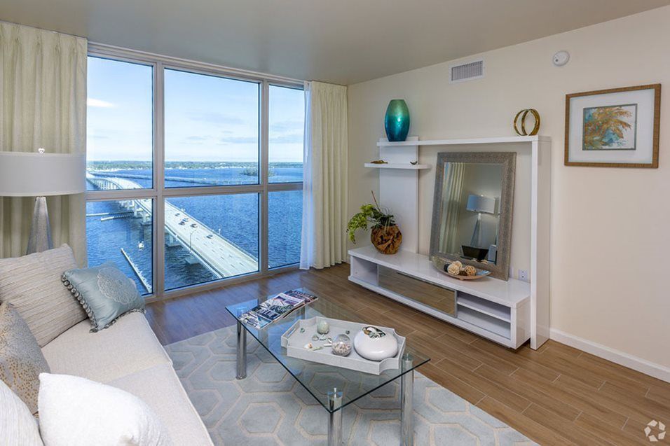 A modern living room with a stunning ocean view, featuring sleek decor and ample natural light.