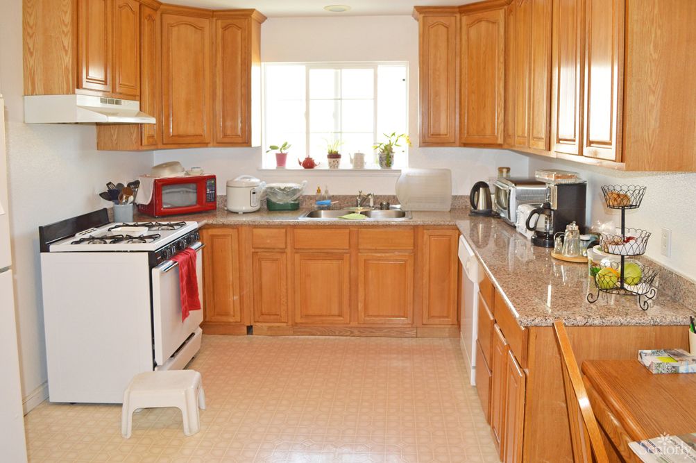 A spacious kitchen with wooden cabinets and modern appliances.
