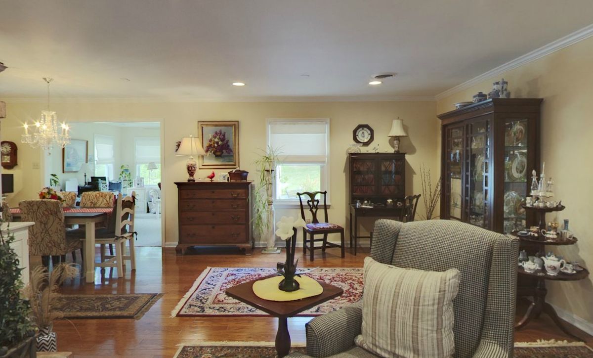 A traditional living room with wood flooring and classic furniture.