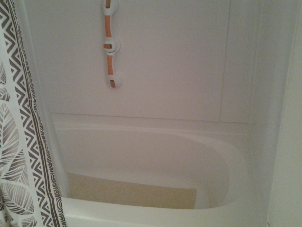 A bathroom with a partially filled bathtub.