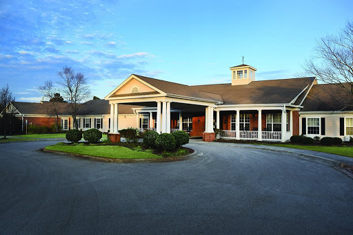A welcoming residential facility with a spacious front entrance and well-maintained landscaping.