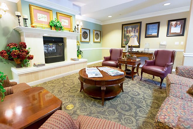 A cozy living room with elegant furniture and a warm fireplace.