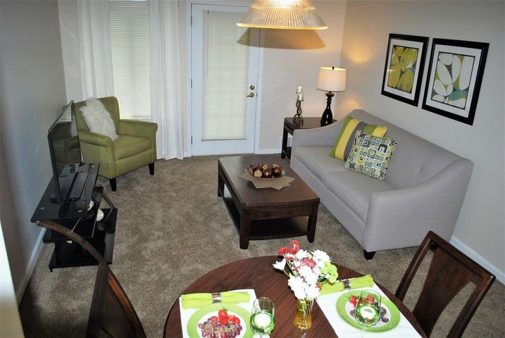 A cozy living room and dining area with modern furniture and decor.