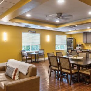 A modern open-concept living space with a kitchen, dining area, and seating.