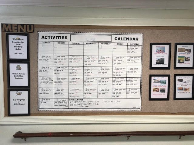 A bulletin board displaying a monthly activities calendar in a community center.