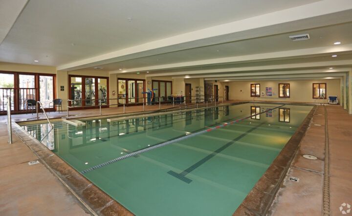 An empty indoor swimming pool with a serene atmosphere.