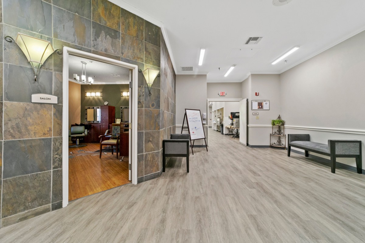 A modern office interior with a spacious waiting area and hallway.