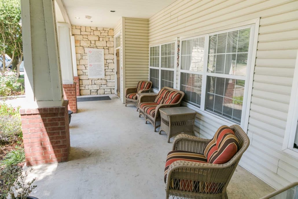 A cozy porch with wicker chairs and colorful cushions, perfect for relaxation.
