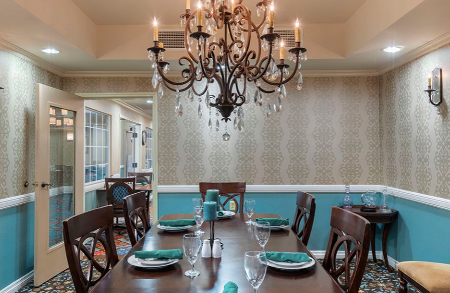 A beautifully set dining room featuring an elegant chandelier and stylish decor.