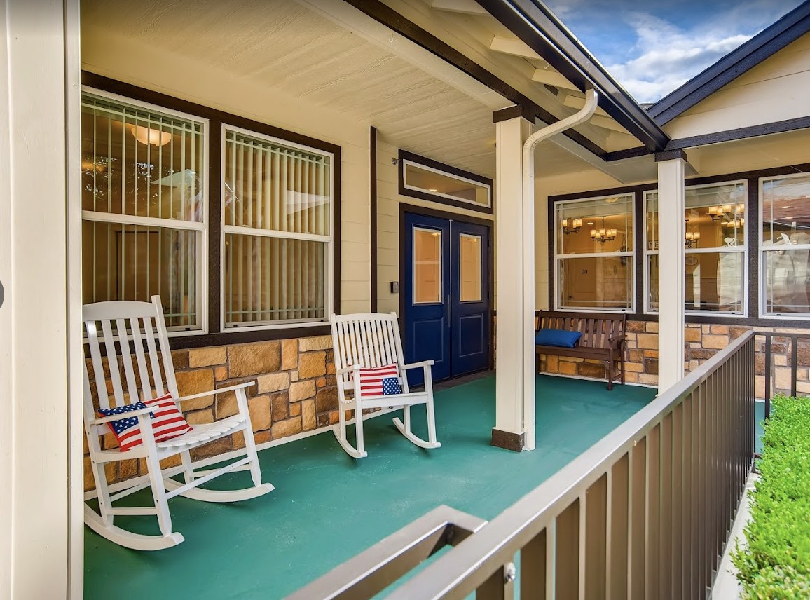 A cozy front porch with rocking chairs and decorative elements.
