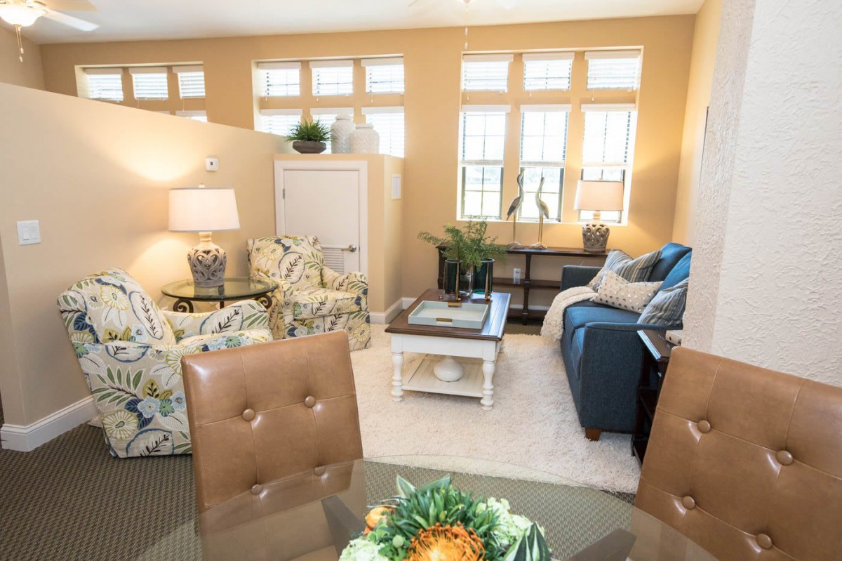 A cozy living room with a mix of comfortable seating, stylish decor, and ample natural light.