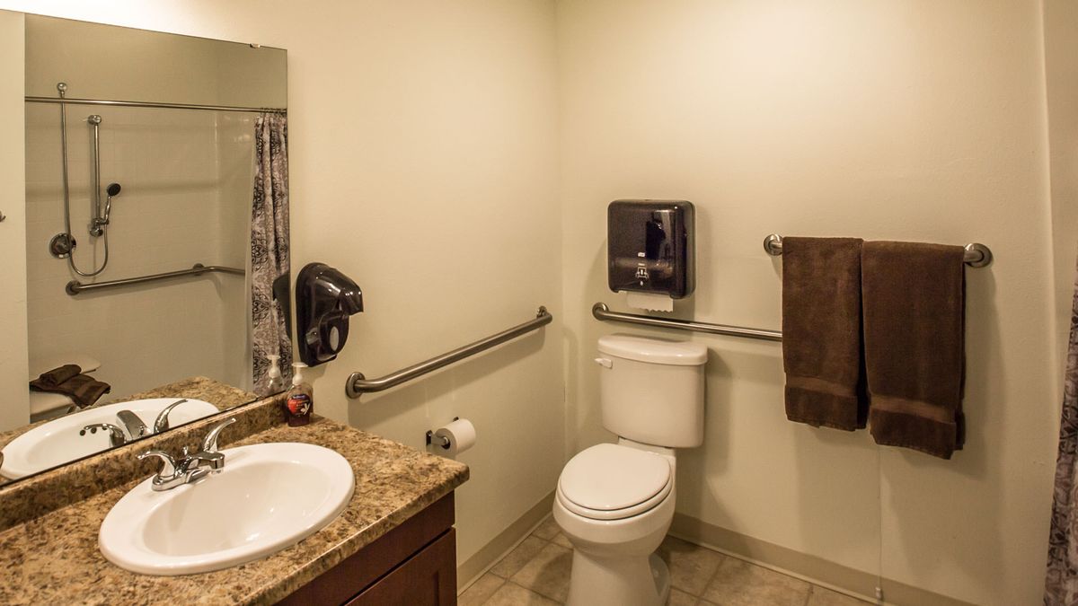 A clean and accessible bathroom with safety rails.