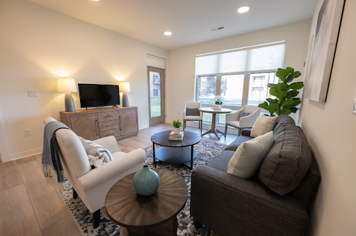 A beautifully designed living room featuring modern furniture and plenty of natural light.