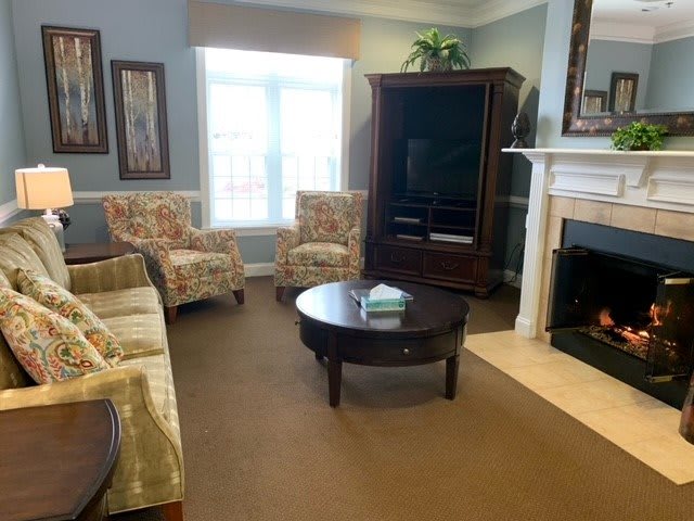 Cozy living room with comfortable seating, a fireplace, and entertainment center.