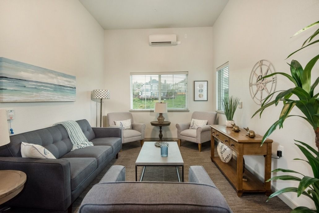 A modern living room with comfortable seating, stylish decor, and ample natural light.