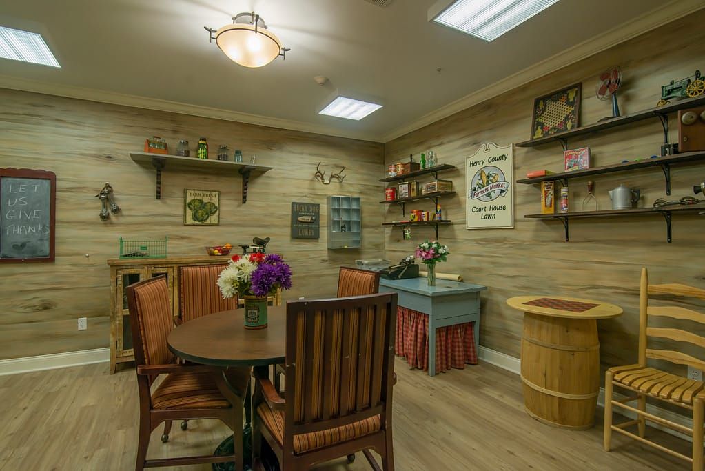 A cozy, vintage-inspired dining area with wooden furniture and colorful flowers.