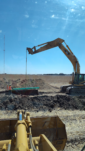 An excavator lifting soil during a construction project.
