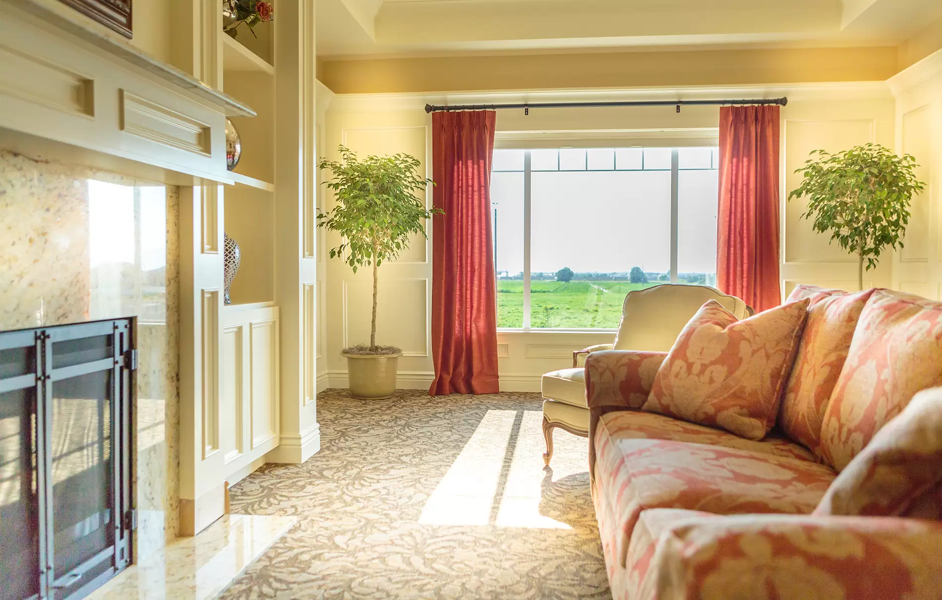 A cozy living room bathed in sunlight, featuring a comfortable sofa, elegant curtains, and a large window with a view of the outdoors.