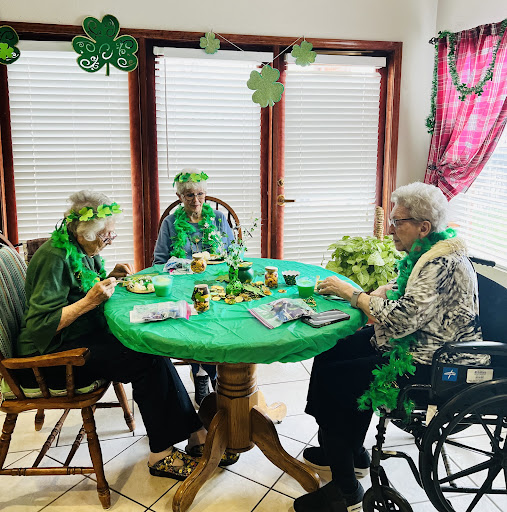 Seniors enjoying a festive St. Patrick's Day celebration with green decorations and crafts.