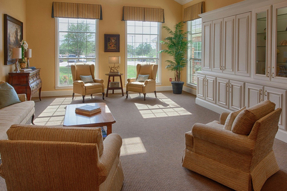 A bright and cozy living room with comfortable seating and large windows.