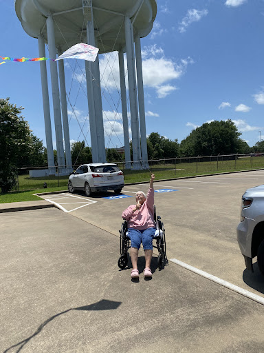 A joyful moment captured under a sunny sky with a remarkable landmark in the background.