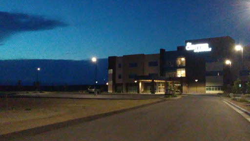 A quiet night scene featuring a modern building under the twilight sky.