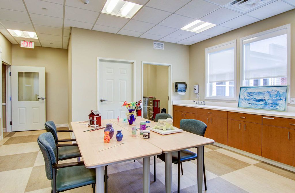 A meeting room with a conference table, chairs, and decorations.