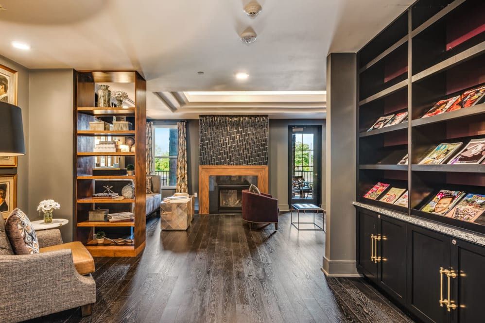 A modern living room with a cozy fireplace and built-in bookshelves.