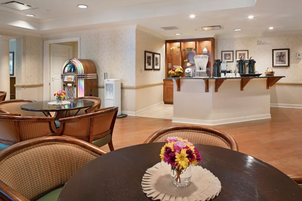 A cozy lounge with a seating area, coffee bar, and a jukebox.